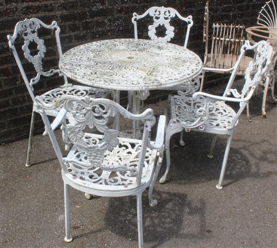 Four white painted metal chairs, similar table , 2 wrought iron chairs